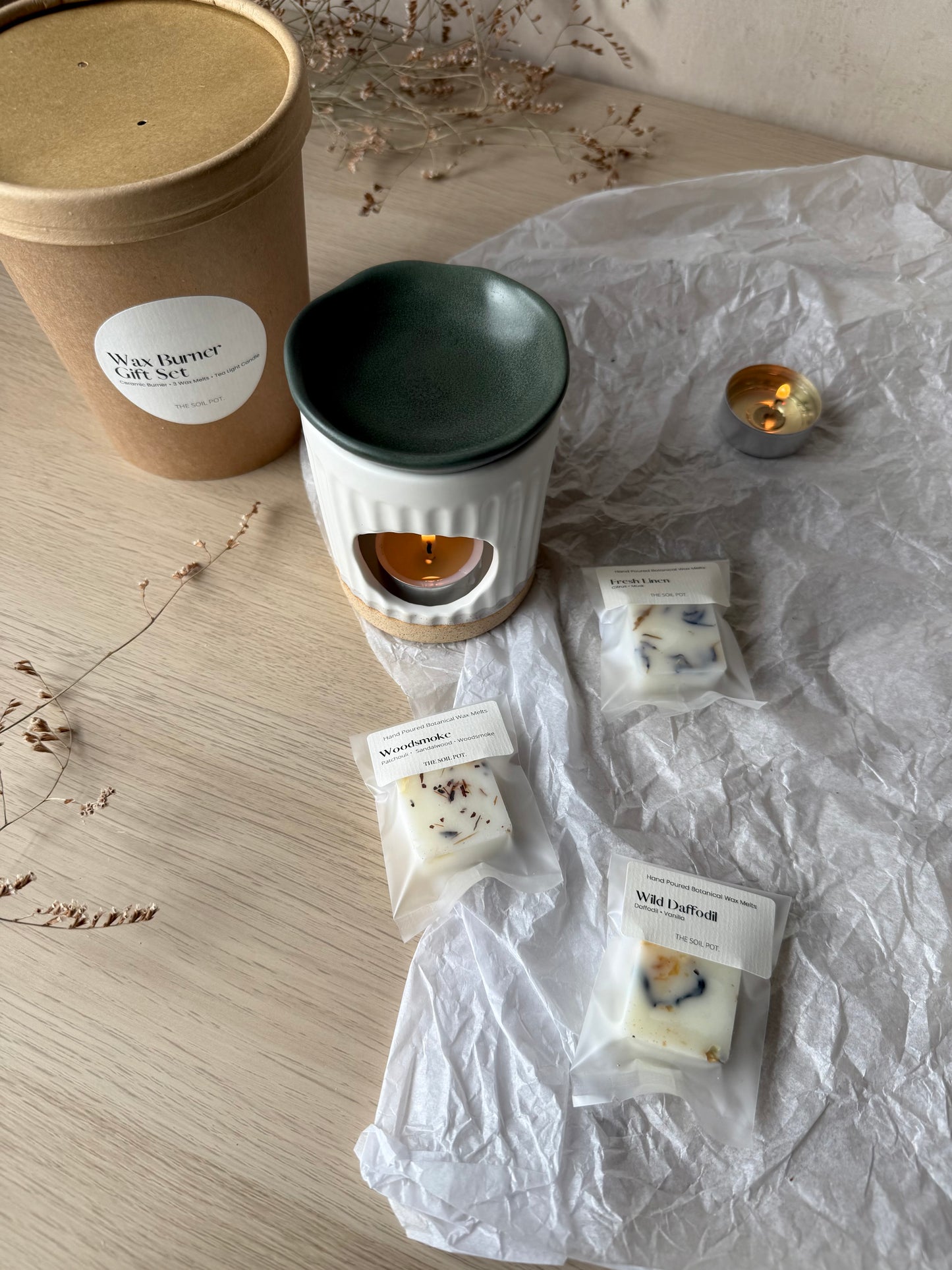 Wax burner set with wax melt samples an on a wooden surface