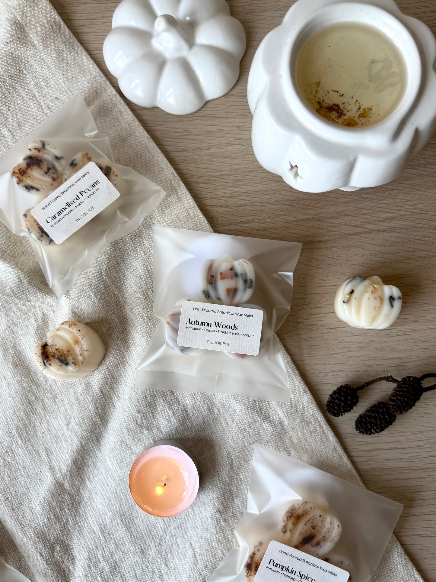 small pumpkin shaped wax melts on cream cloth and wooden table